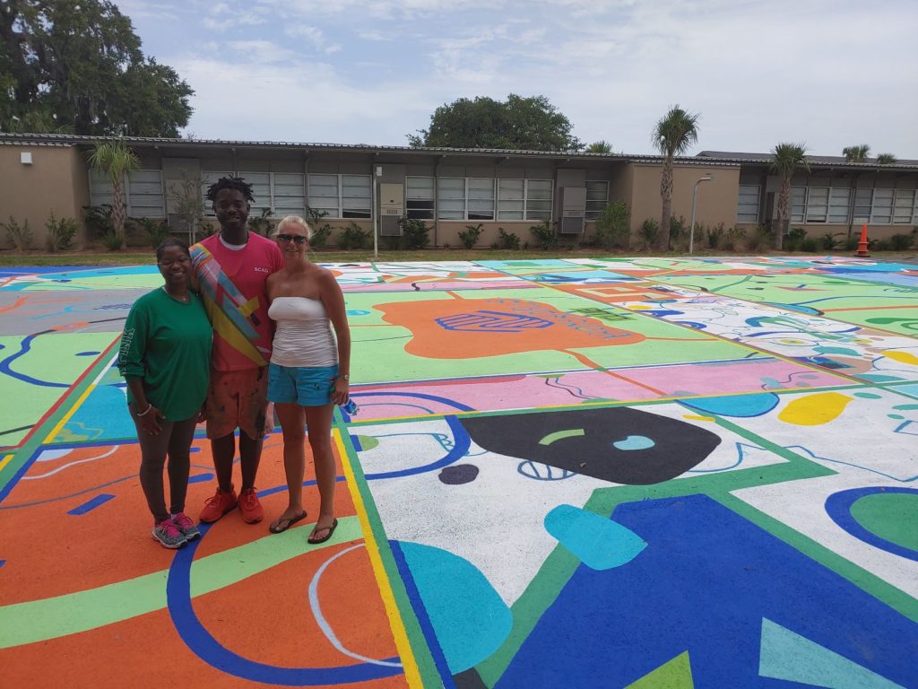 Tracy with Kevin and Britney standing on the play ground.